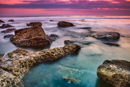 Evening view of the beach with stone and mysterious atmosphere from island Bali/Indonesia/
