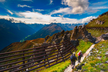 Old couple hiking on hiking trails of Stubai Alps in Austriaの写真素材
