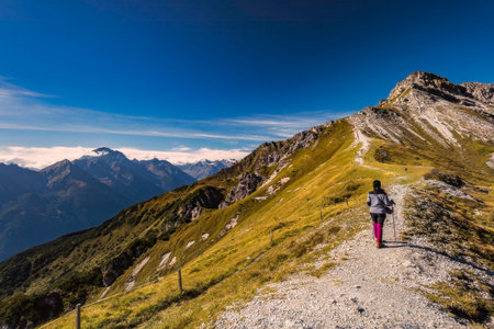 View of the mountain alpine landscape from Austria with a female touristの写真素材