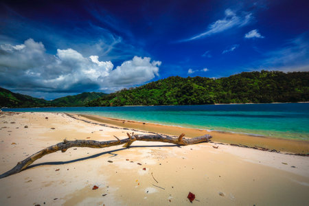 View of the sea from the beach of Kilian Bay in Indonesia on a sunny dayの写真素材