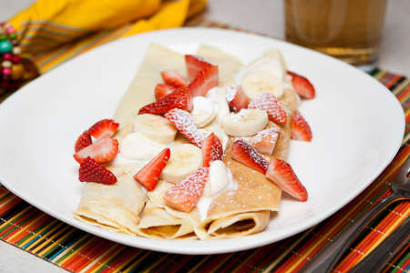 Crepes with strawberry, banana and whip creamの写真素材