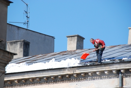 Lublin City, Poland - March 18, 2013 - Man cleaning roof from snowのeditorial素材