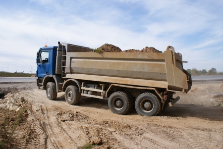 This is a view of truck on the highway building placeの写真素材
