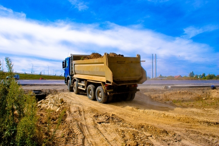 This is a view of truck on the highway building placeの写真素材