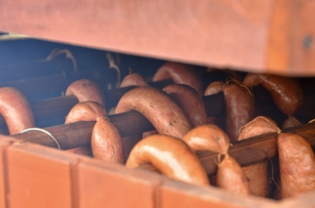 This is a view of meat smoking in small home smokerの写真素材