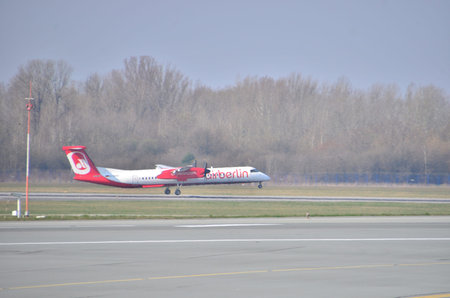 This is a view of Air Berlin plane Bombardier Q400 Dash-8 registered as D-ABQF on Warsaw Chopin Airport. April 11, 2015. Warsaw, Poland.のeditorial素材