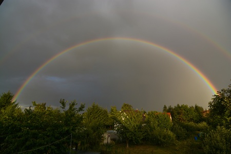 This is a view of a double rainbow on the sky.の写真素材
