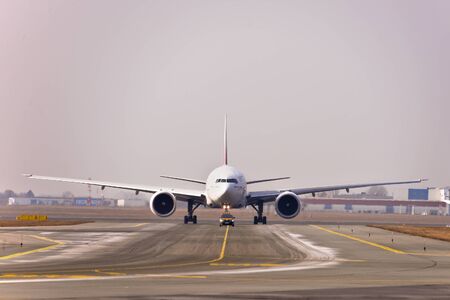 This is a view of Emirates plane Boeing 777-300R registered as A6-EQA on the Warsaw Chopin Airport.のeditorial素材