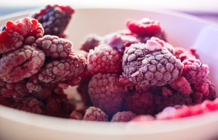 Macro on Frozen Raspberries in bowl
