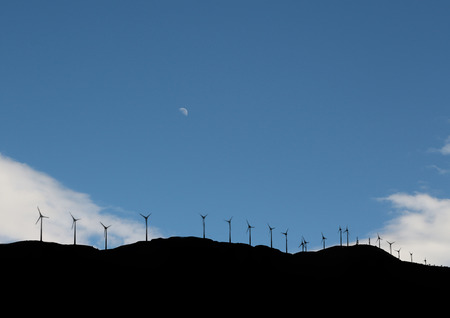 Multiple Wind turbines up on a Hill, Silhouetteの写真素材