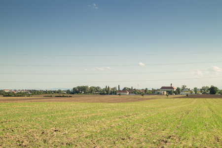 Crop land, landscape field with small Village on the Horizonの写真素材