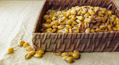 Roasted Corn in woven Basket on Tableclothの写真素材