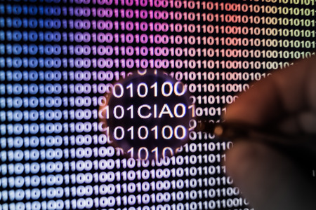 Binary code, CIA spotted by hand holding magnifying lupe, tonedの写真素材