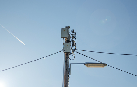 Electric cables wiring and public light on poleの写真素材