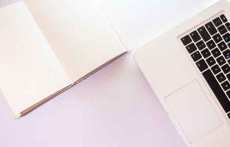 Working table overhead view,  Laptop and blank Book white isolatedの写真素材