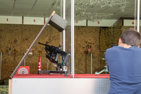 Amusement park Boy shoot air gun at fair, Vienna Austria 26.August 2017のeditorial素材