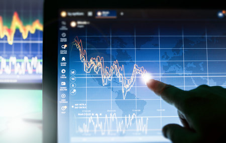 Crypto Currencies, Hand showing graph charts on screen