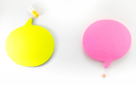 Yellow pill and red tablet with speech text bubbles copy spaceの写真素材