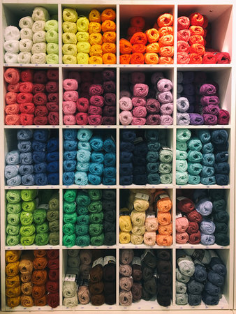 Colorful pastel knitting wool yarns in shelf