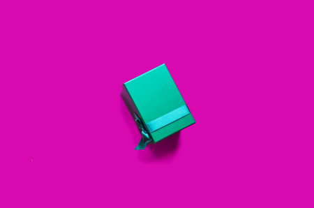 Single green present box on pink backgroundの写真素材