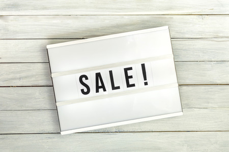 Light box with sale letters on white wooden table, top viewの写真素材