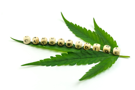 Cannabis leaf with letter beads showing Cannabidiol wordの写真素材