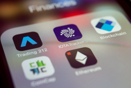 Close up macro of Trading and Blockchain apps on iPhone screen, Vienna Austria 23.Jan.2018