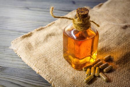 Glass bottle with Cannabis CBD oil and CBD pills on Hemp cloth, medical marijuana conceptの写真素材