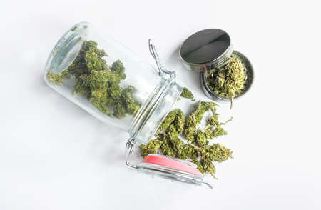 Homegrown marijuana in a mason jar buds and grinder on isolated on white, Medical Cannabis conceptの写真素材