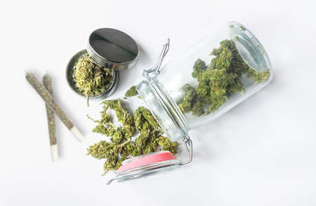 Medical marijuana in a mason jar buds joint and grinder on isolated on white, Medical Cannabis conceptの写真素材