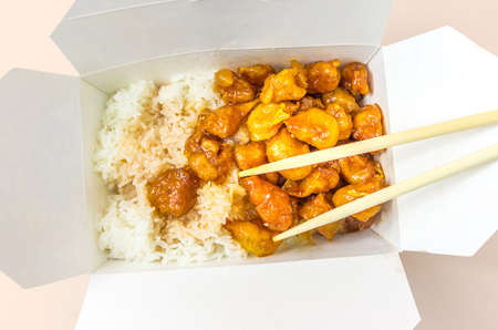Chinese Food Sweet and Sour, Orange or Lemon Chicken in a Take Out Container with chopsticksの写真素材