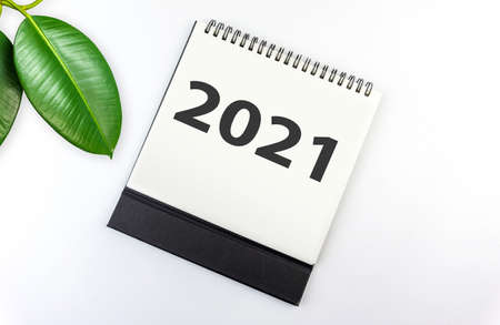 New year 2021 concept: flat lay of desktop calendar on white backgroundの写真素材