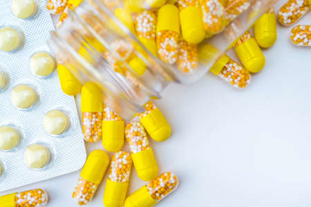 Open container with vitamin D3 capsules isolated on white backgroundの写真素材
