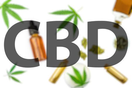 CBD letters written against various Cannabis products on white backgroundの写真素材