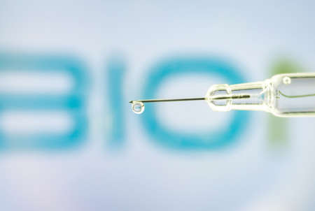 Vienna Austria Jan 28, 2021, Syringe with liquid drop against BionTech logo, a German biotechnology company based in Mainzのeditorial素材