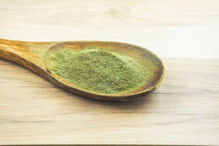 Kava Kava powder in wooden spoon, a natural medicinal plant for relaxation used as a drinkの写真素材