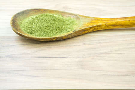 Kratom Mitragyna Speciosa an alternative medicine powder in wooden spoon with copy spaceの写真素材