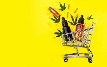 CBD oils Capsules leafs in shopping cart, Shopping Cannabis products conceptの写真素材