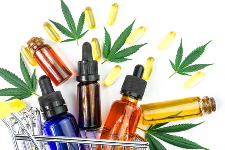 CBD oils Capsules leafs in shopping cart, Shopping Cannabis products concept isolated on whiteの写真素材
