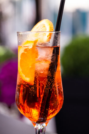 Aperol spritz with orange slice at outside cafe Aperol is an Italian aperitif made of herbs and sodaの写真素材
