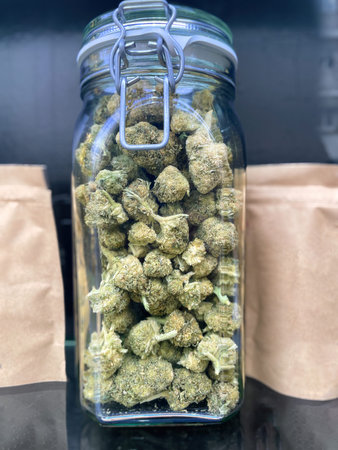 Glass jar full of Meical Cannabis Sativa against dark backgroundの写真素材