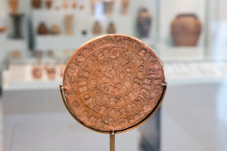 Heraklion, Crete, Greece - 07-01-2017: The Phaistos Disc in Heraklion Archaeological Museum still in exhibition - close up.のeditorial素材