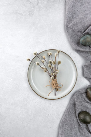 Easter picture with painted eggs on a plate. Willow branch. The minimal concept of Easter. An Easter...