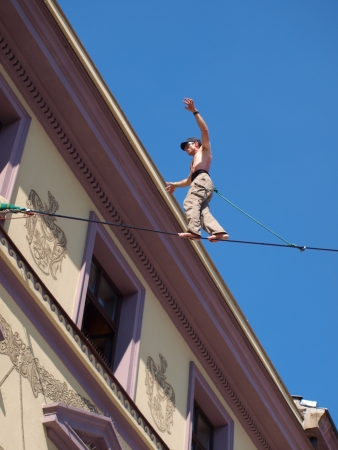 Lublin, Poland, August 21st 2010: A tightrope walker in the historic old town of Lublin during summer Festival of Circus Art (Carnival Sztuk-Mistrzow).のeditorial素材
