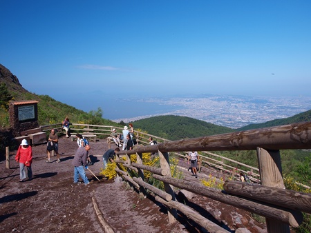 In the background the city of Naples and the Naples Bay. In the foreground people climbing Vesuvius. Italyのeditorial素材