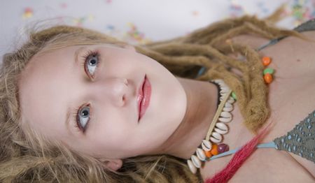 a pretty blond girl laying on the floor, surrounded by candiesの写真素材