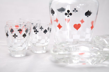 a set of shot glasses with pattern of cards