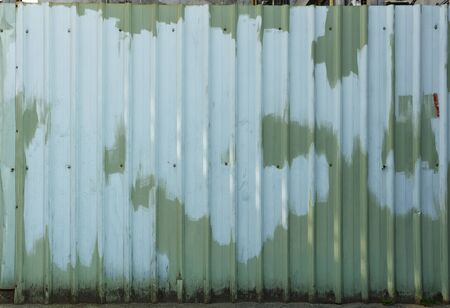 Green and blue painted fenceの写真素材