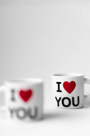 Two cups of tea with a red heart and the inscription I love youの写真素材