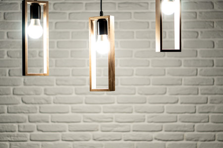 Three lamps on a background of a white brick wall. Three light bulbs on a white brick background....
